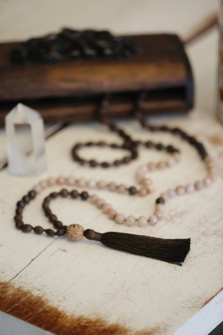 A Mala Beads Necklace With Brown Tassel