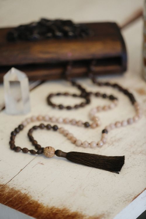 Free Close-up of handmade mala beads with tassel, made from natural stones and crystal, on wooden background. Stock Photo