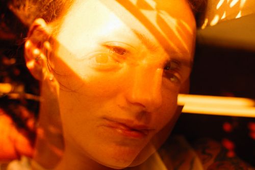 Free Artistic double exposure portrait of a woman with sunlight and warm colors creating a dreamy effect. Stock Photo