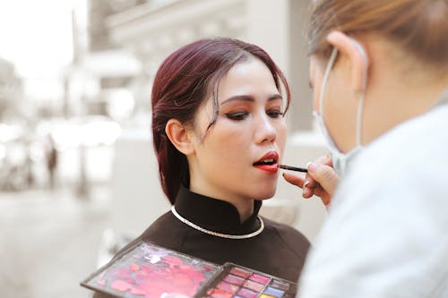 Free Putting Lipstick on a Woman Stock Photo