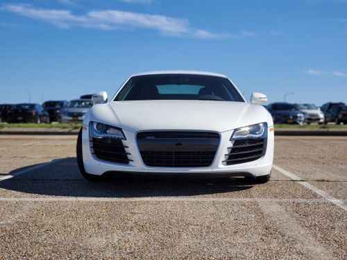 Free Front view of a white sports car parked in a lot in Queens, NY, on a sunny day. Stock Photo