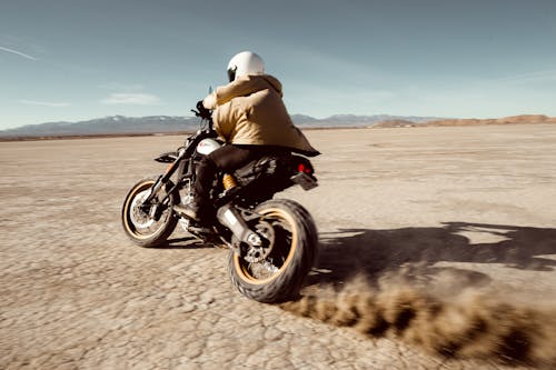 Person Riding Bike Through Desert