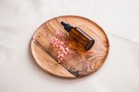 Brown Glass Bottle on Brown Wooden Round Table