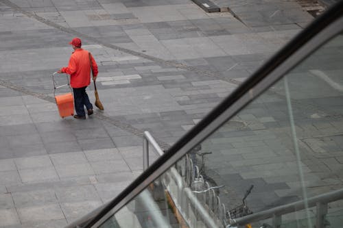 Cleaner with Broom in Town 