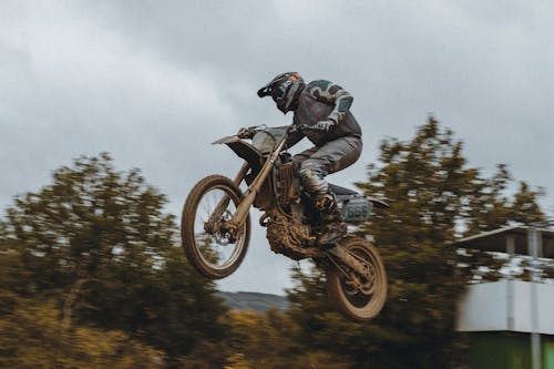 Free Man in Black Jacket Riding Motocross Dirt Bike Stock Photo