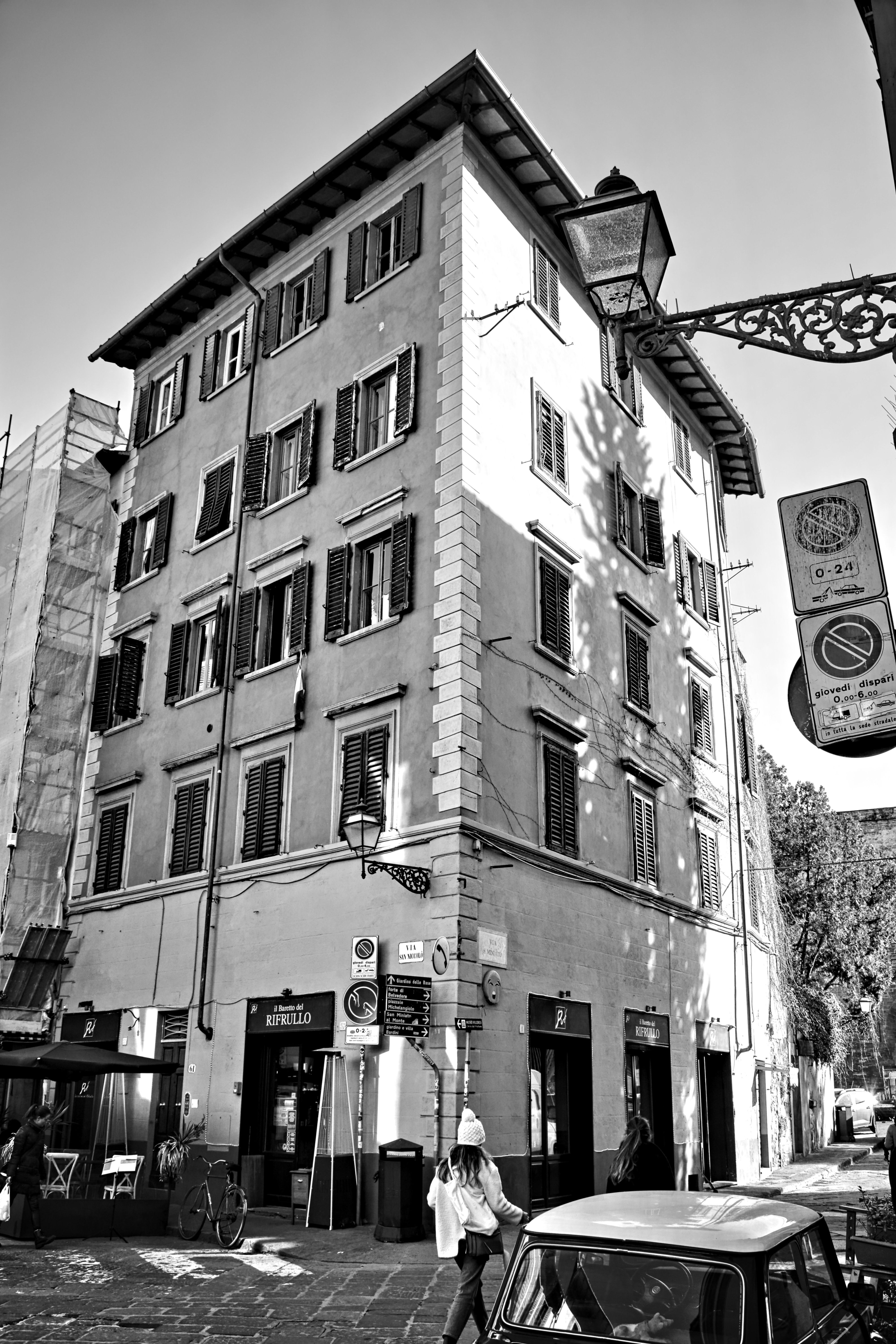 Black and white photo of a city street with a vintage feel, capturing urban architecture.