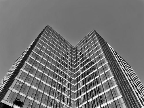 Free Striking black and white low-angle shot of a modern skyscraper facade. Stock Photo