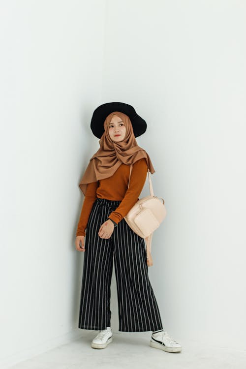 Woman in Brown Long-sleeved Shirt and Brown Hijab Headdress With Beige Leather Backpack