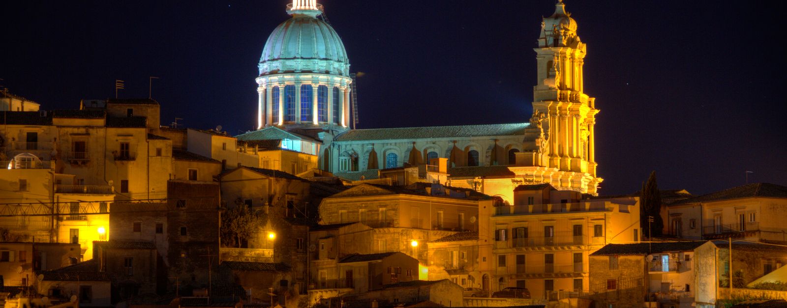 Spectacular night scene of Ragusa's illuminated cathedral with baroque architecture.