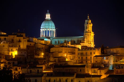 Spectacular night scene of Ragusa's illuminated cathedral with baroque architecture.
