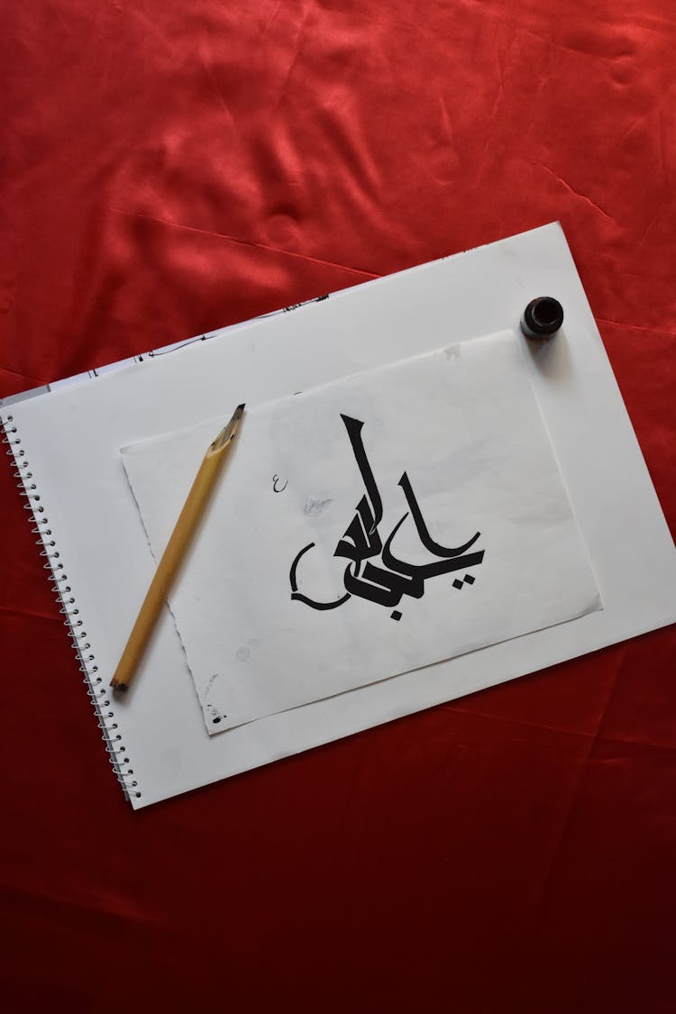 Arabic Calligraphy On White Paper