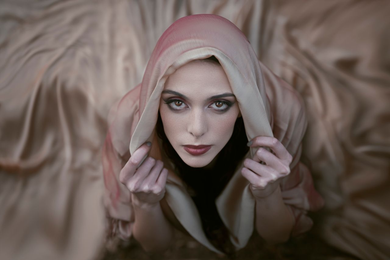 portrait of an elegant woman in a headscarf gazing upwards with a soft