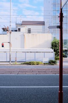 Bright urban street view featuring modern architecture and clear sky.