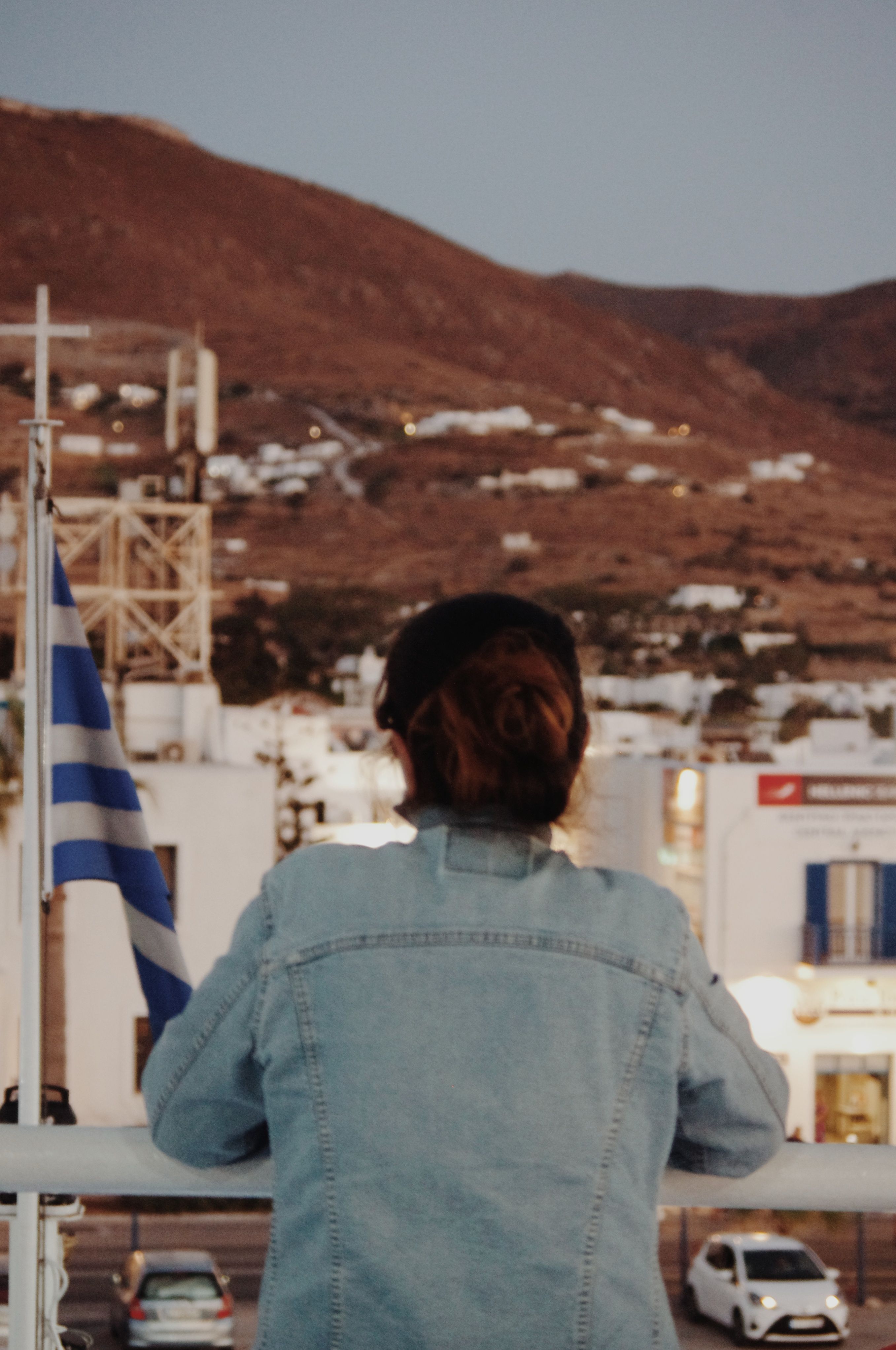 A Back View of a Woman in Denim Jacket · Free Stock Photo