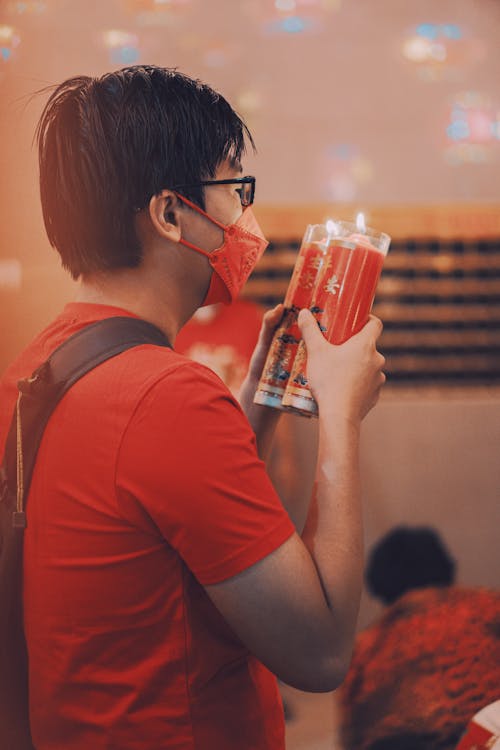 Man with Lit Candles Celebrating Chinese New Year 