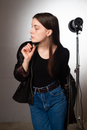 Woman in Black Long Sleeve Shirt and Blue Denim Jeans Standing Near Microphone
