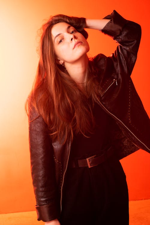 A Woman in Black Leather Jacket with Her Hand on Her Head