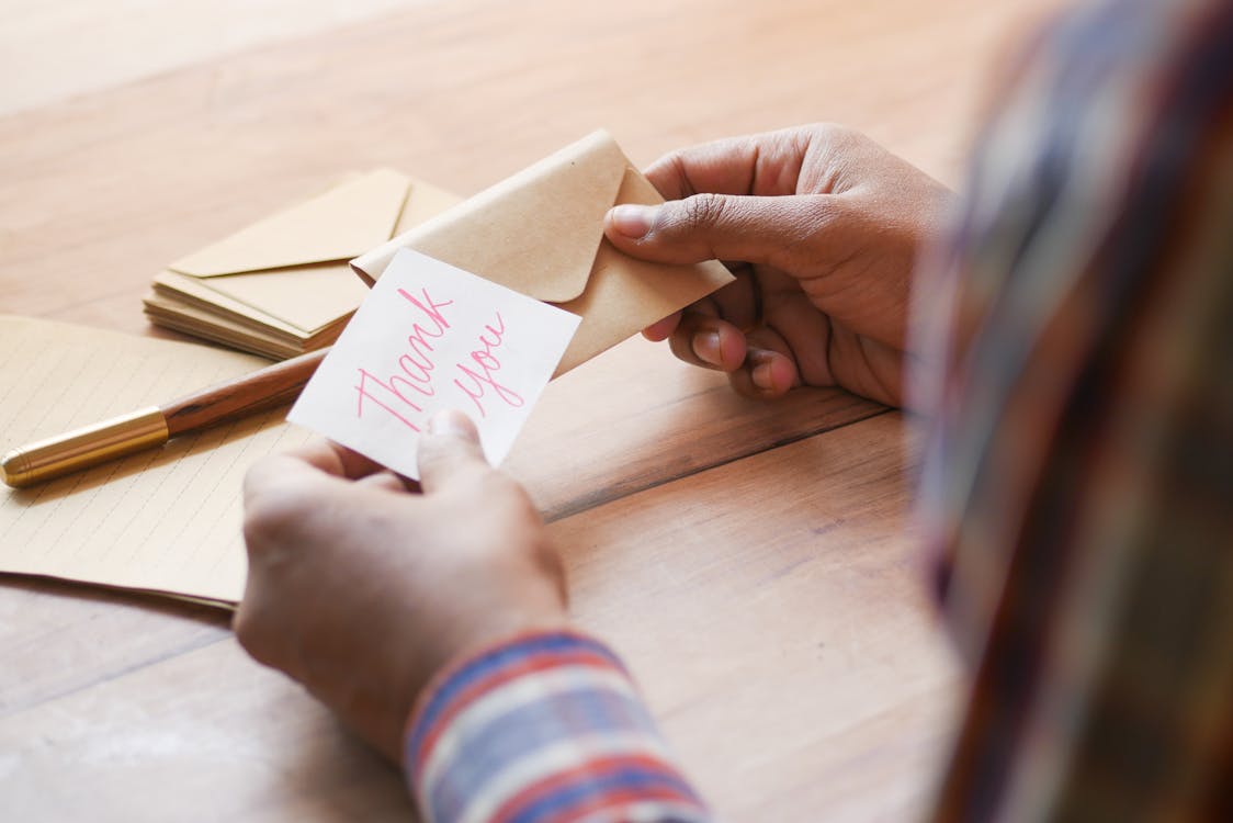 Free Hands Holding Thank you Note and Envelope Stock Photo