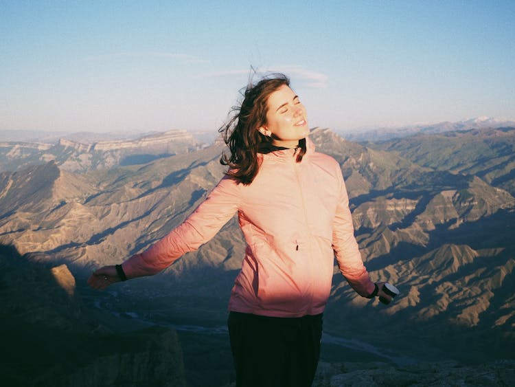 Smiling Woman On Top Of Mountain