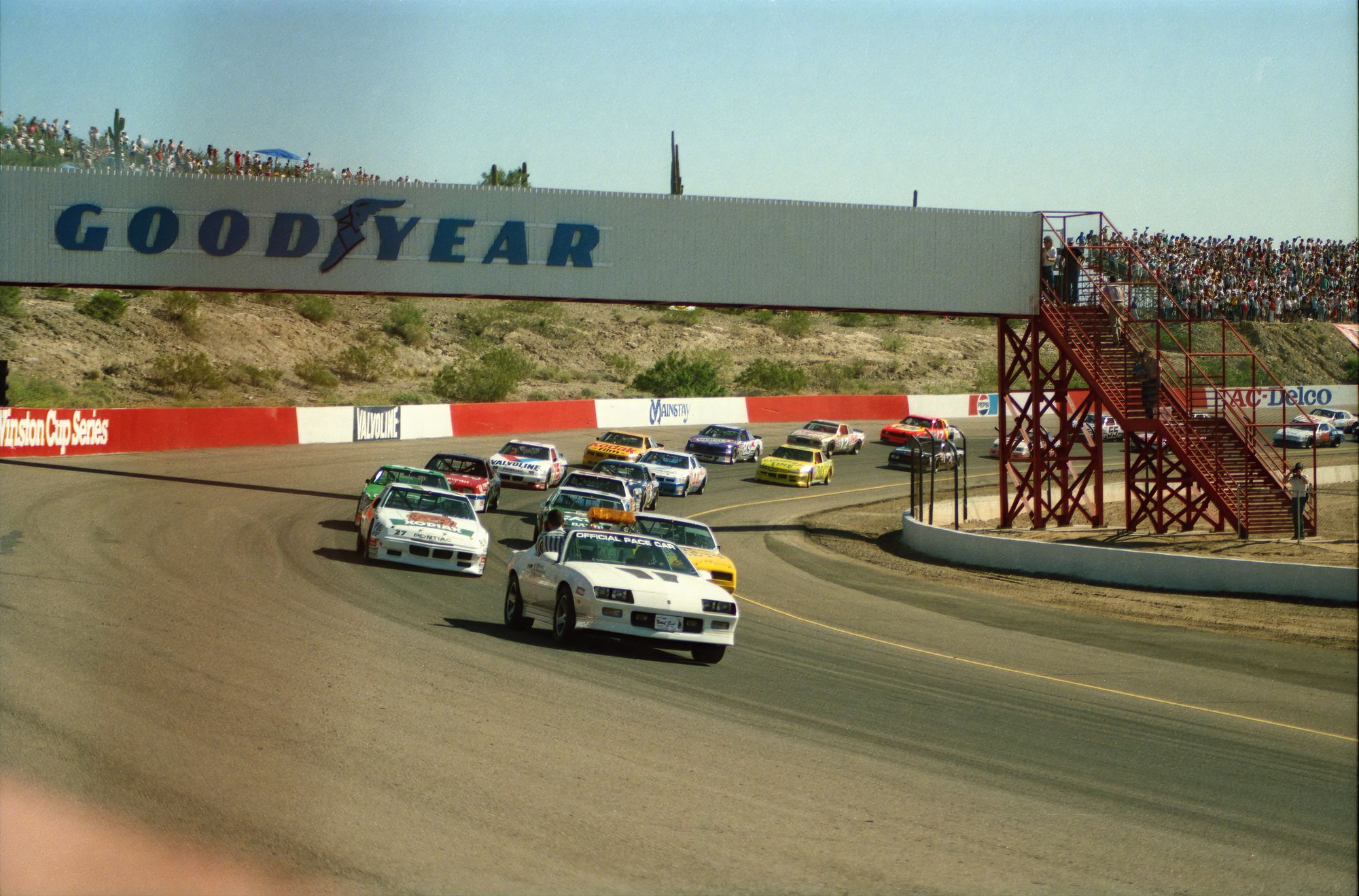 Period-correct late-1980s NASCAR Winston Cup cars on a superspeedway matches the film
