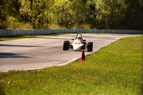 Free Vintage race car speeding on an outdoor track at Elkhart Lake. Stock Photo