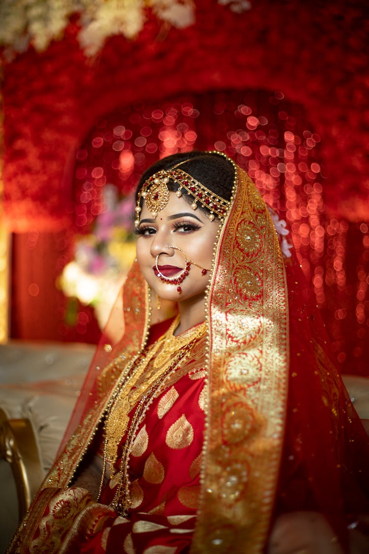 Beautiful Woman In Gold And Red Traditional Clothing