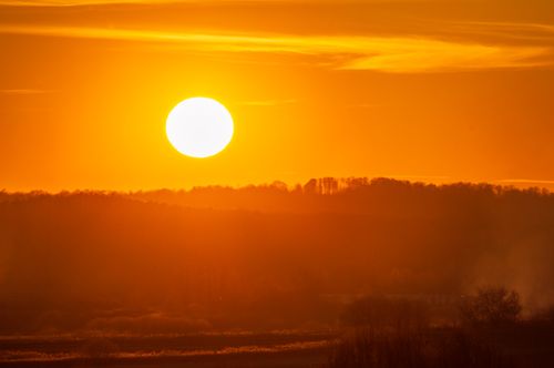 Free Stunning golden sunset casting warm hues over a peaceful landscape, capturing the essence of nature's beauty. Stock Photo