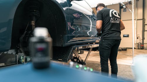 Free A Man Repairing a Car  Stock Photo