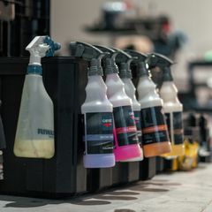 A row of colourful car-care spray bottles