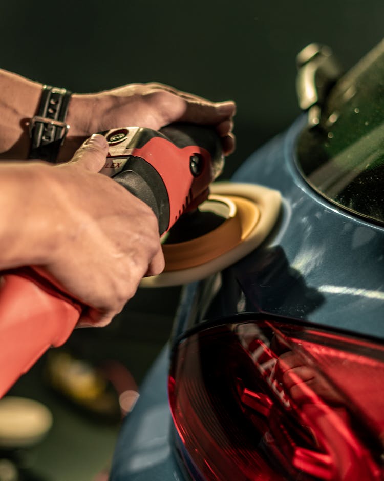 A Person Buffing A Car 