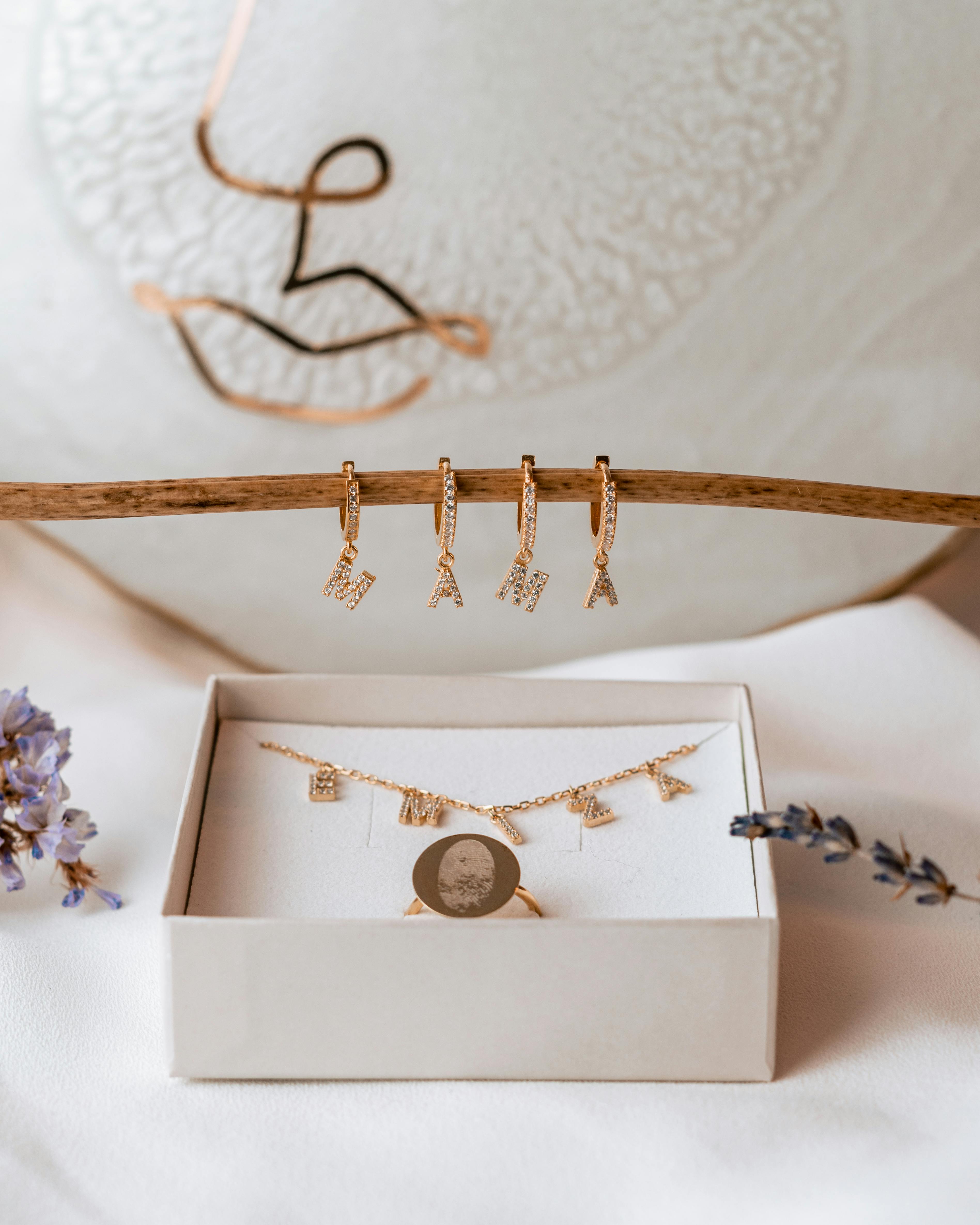 Luxurious gold jewelry set elegantly displayed with delicate floral accents. Perfect for modern luxury themes.