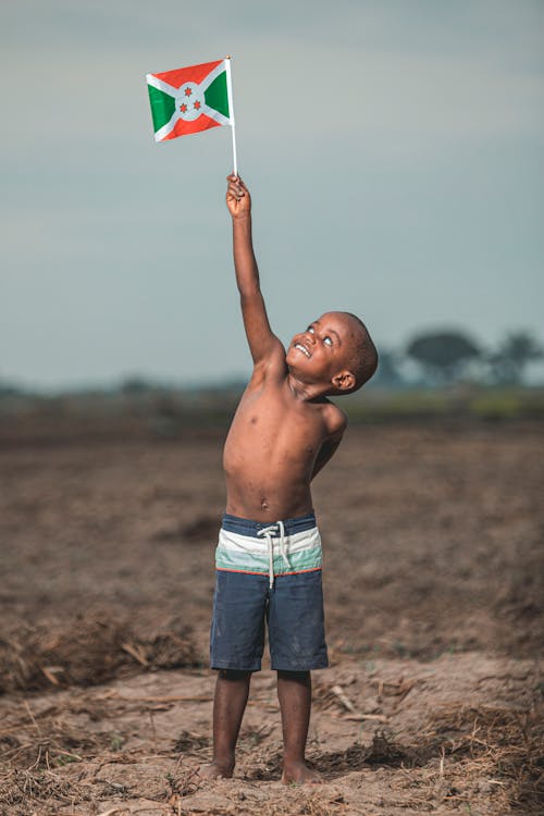 Boy Raising Burundi Flag