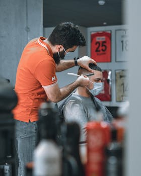 Barber giving a masked customer a haircut, embracing the new normal at a barbershop.