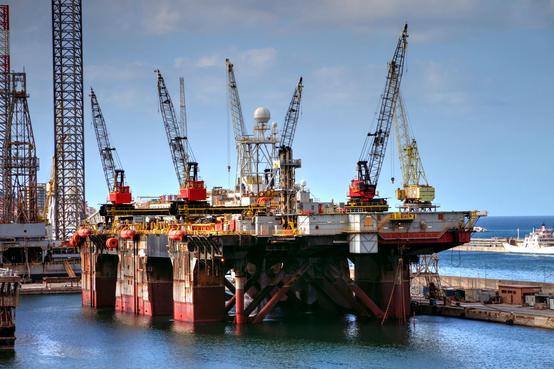 Offshore oil platform with cranes in Palermo harbor, capturing industrial and marine infrastructure.