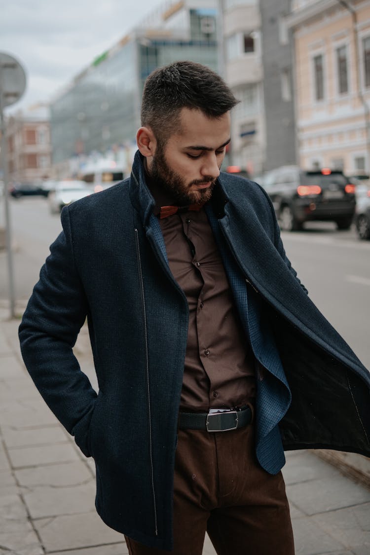 Man With Beard In Suit, Coat And Bowtie Looking Down