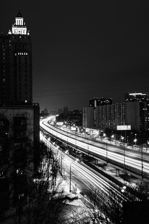 Grayscale Photo of City Buildings during Nighttime