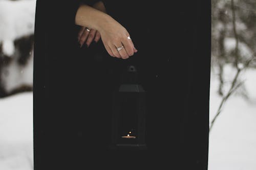Close-Up Shot of a Person Holding a Lantern Lamp