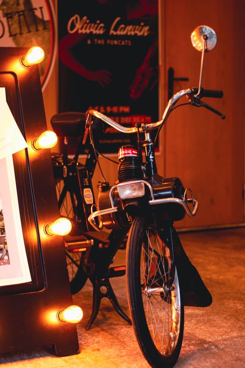 Free A vintage bicycle indoors with warm glowing lights, highlighting its classic charm. Stock Photo