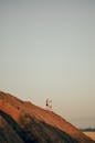 Man and Woman Walking Down Rocky Hill