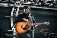 Man in Black Jacket Playing Brown Acoustic Guitar