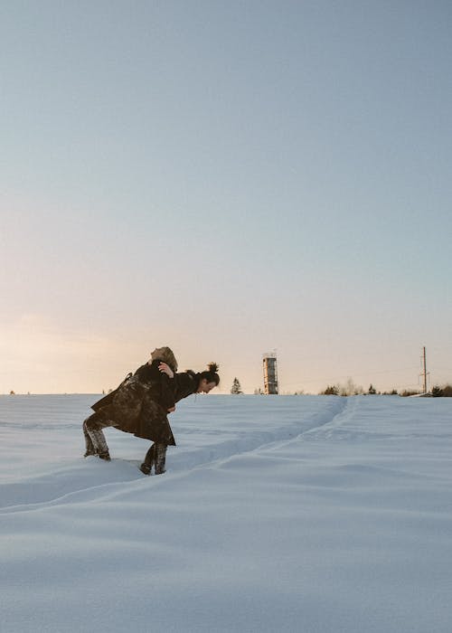 Romantic Couple on Snow Field under the Sky