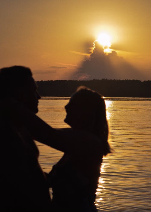 Silhouette of Couple Near Body of Water