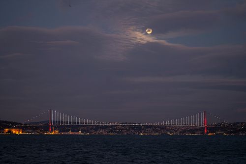 Free Captivating nighttime view of the Bosphorus Bridge in Istanbul under a moonlit sky. Stock Photo