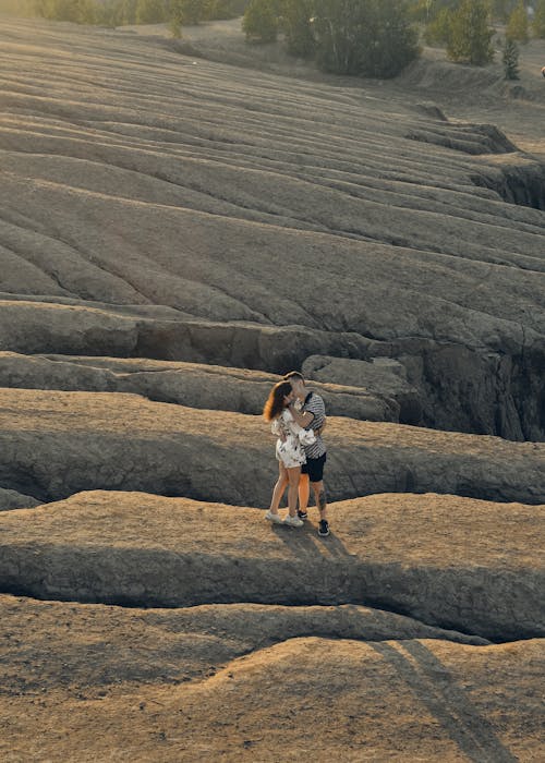 Drone Shot of a Couple Kissing on a Rock