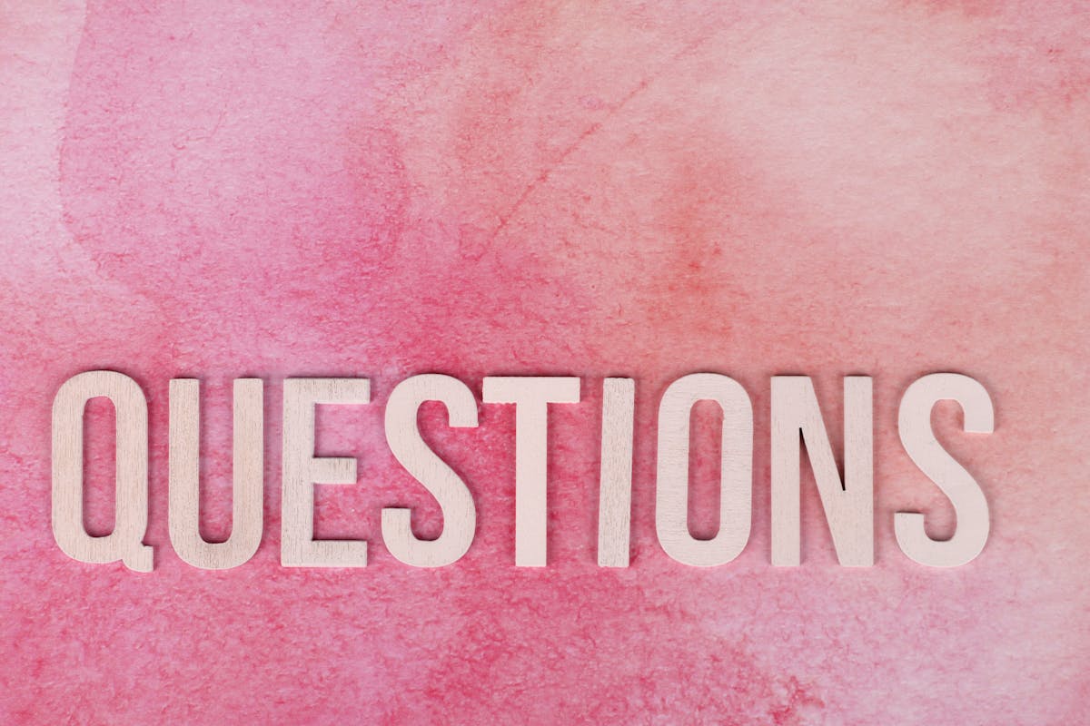 Questions Text on a Pink Surface