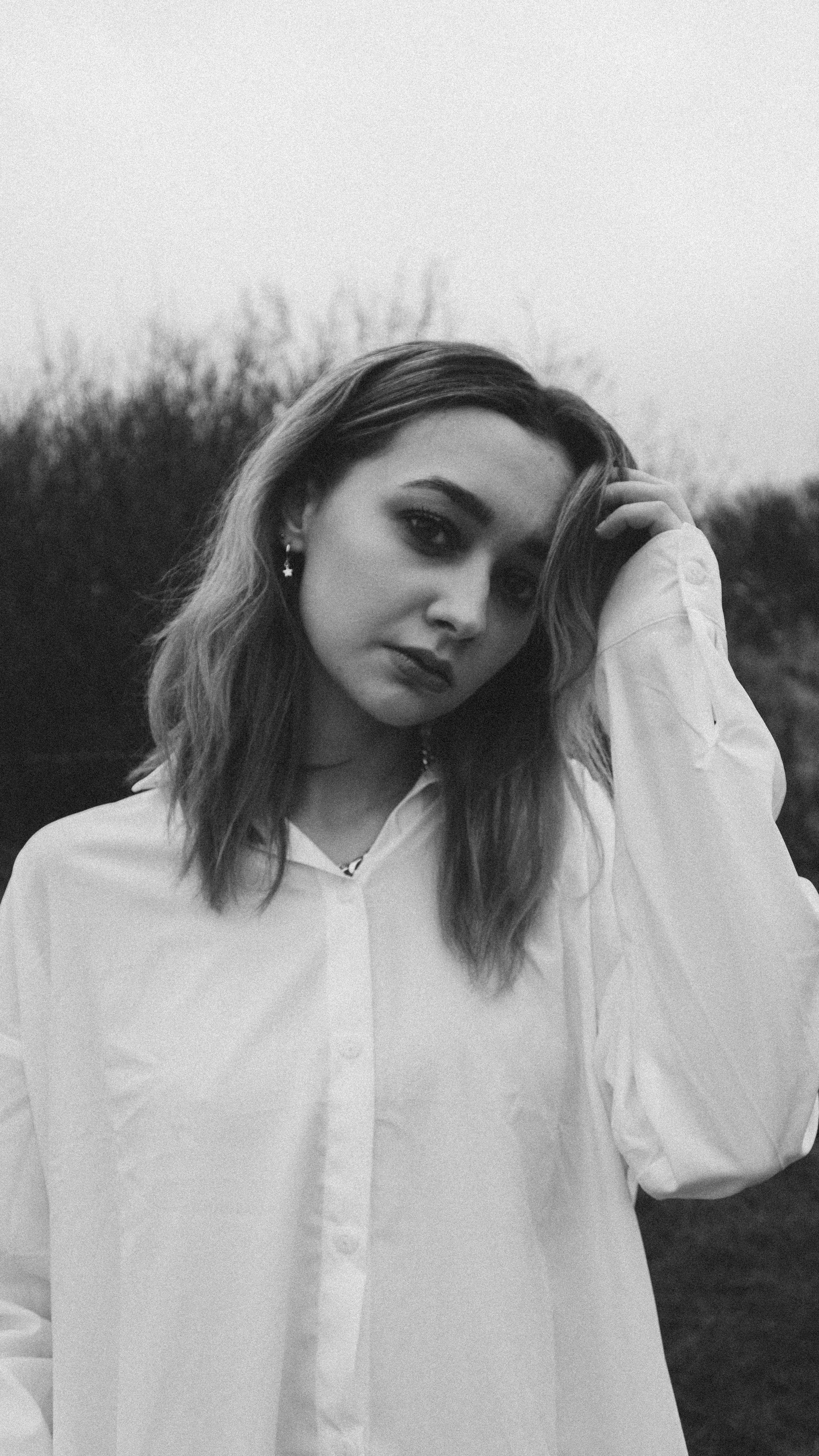 A Grayscale Photo of a Woman in White Long Sleeves · Free Stock Photo