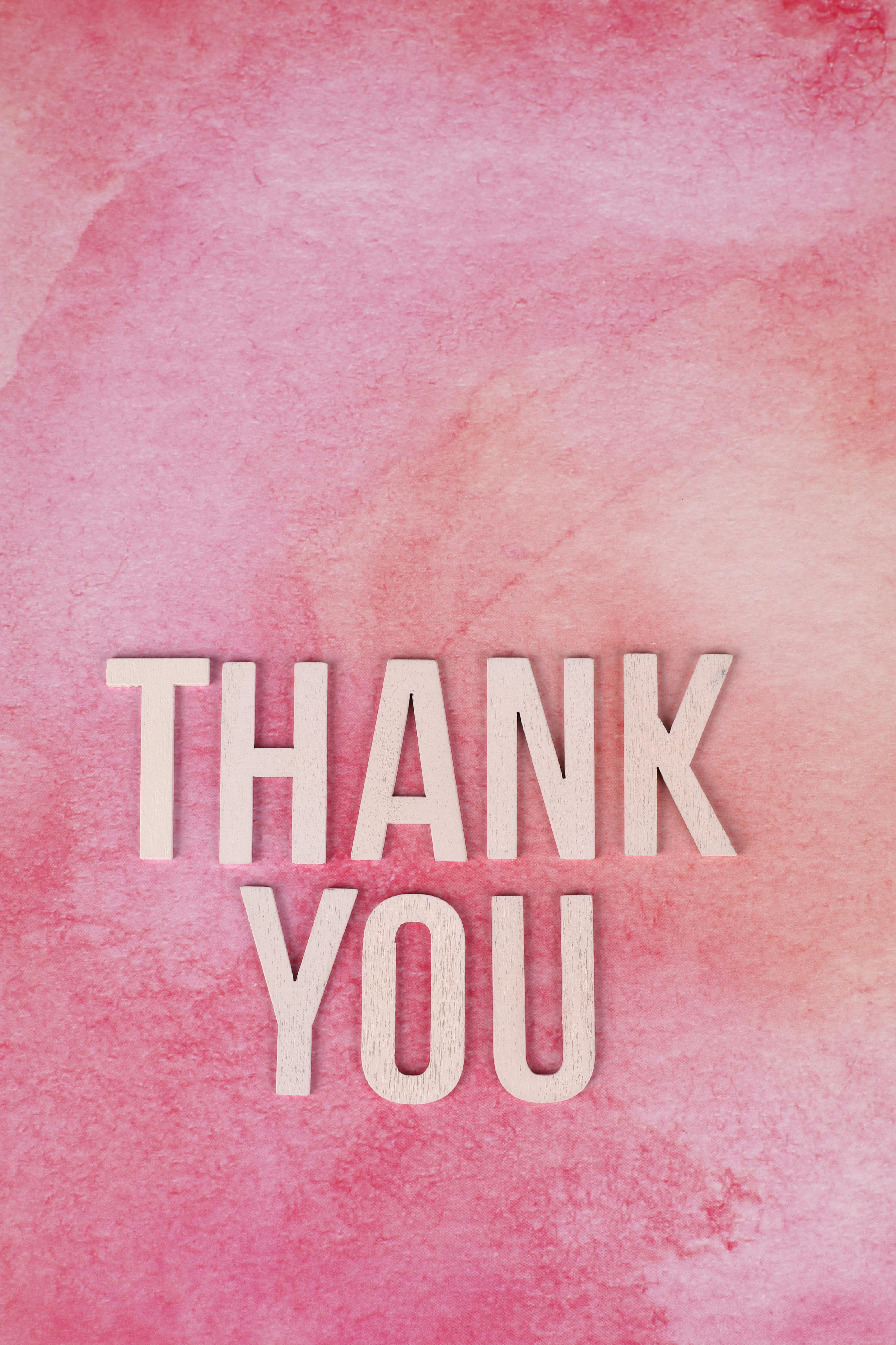 A pink watercolor background with 'Thank You' text for gratitude expression.