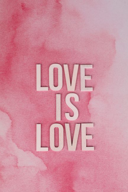 Inspirational 'Love Is Love' text on a vibrant pink watercolor background.