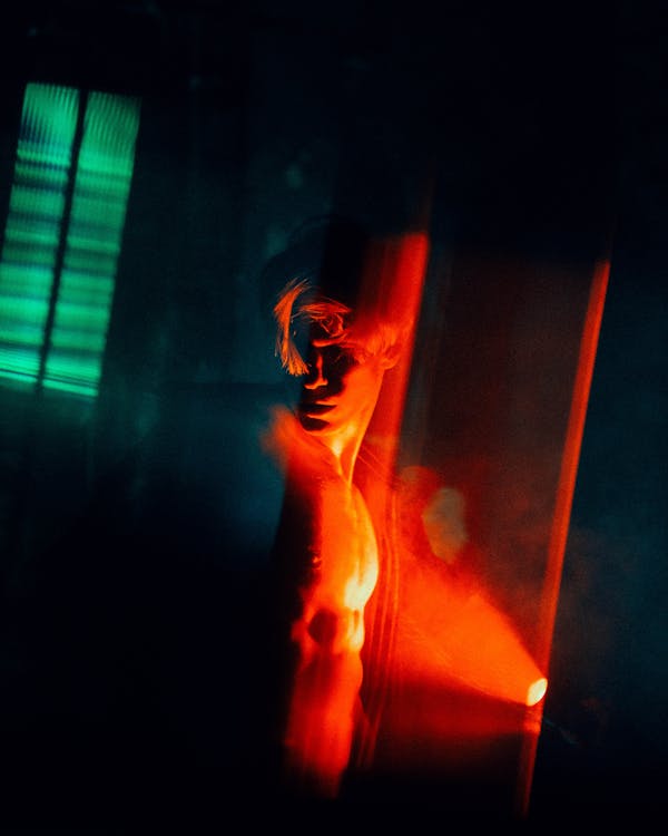 A Shirtless Man with Red Light