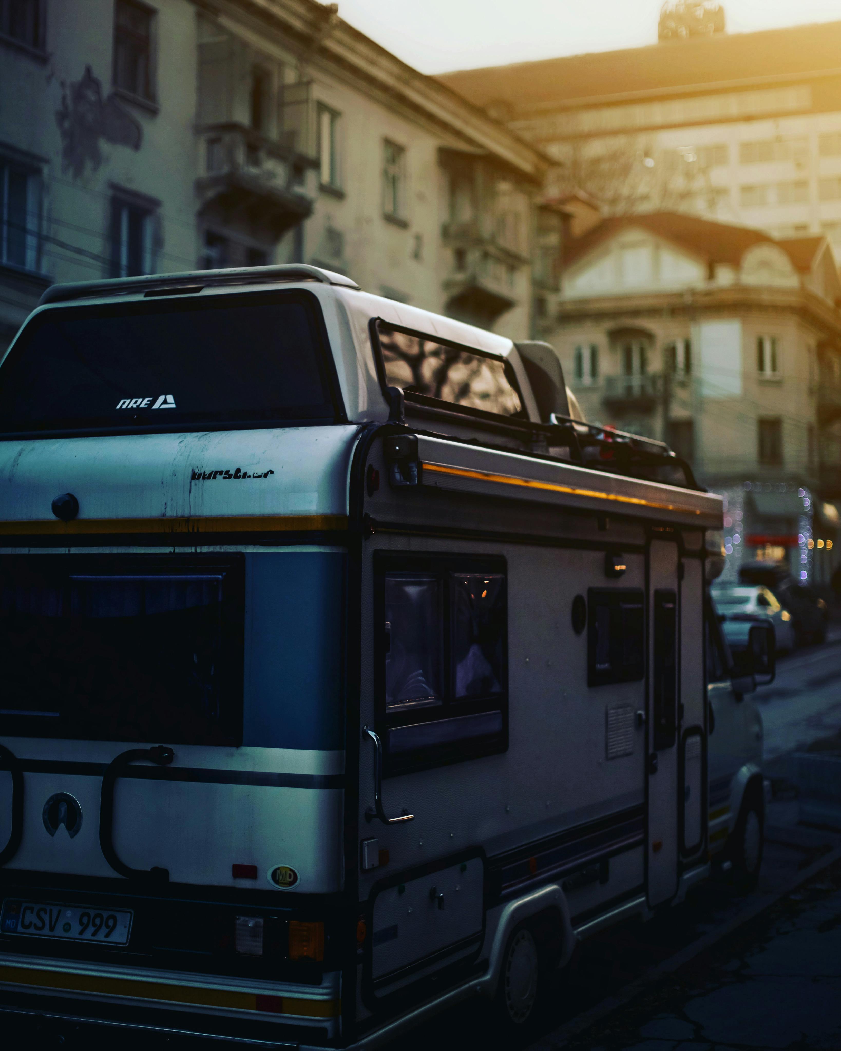 A classic camper van parked on a street in Chisinau, Moldova, during a sunny day.